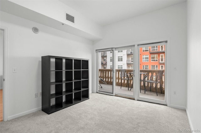 empty room with visible vents, baseboards, and carpet