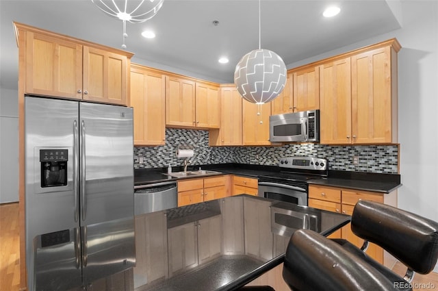 kitchen featuring decorative backsplash, dark countertops, light brown cabinets, and stainless steel appliances