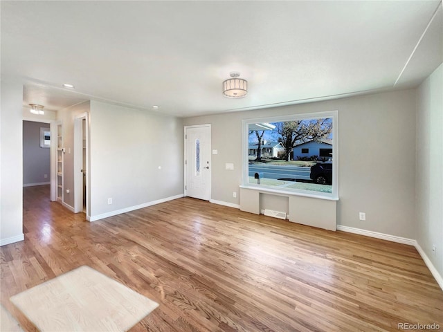 unfurnished living room with hardwood / wood-style flooring