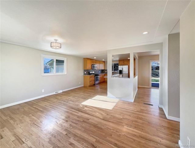 unfurnished living room with light hardwood / wood-style flooring