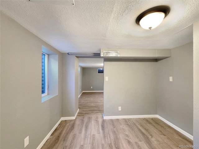 interior space with light hardwood / wood-style floors and a textured ceiling