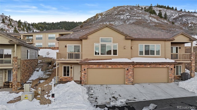 view of front facade with a garage and a mountain view