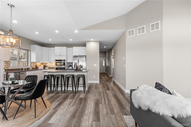 dining room with dark hardwood / wood-style flooring and a notable chandelier