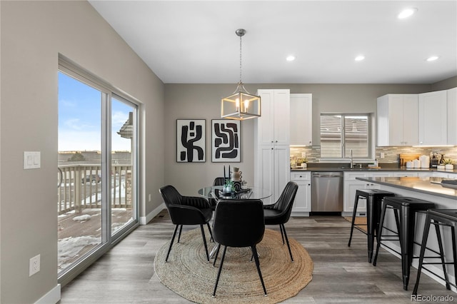 dining area with hardwood / wood-style flooring and sink