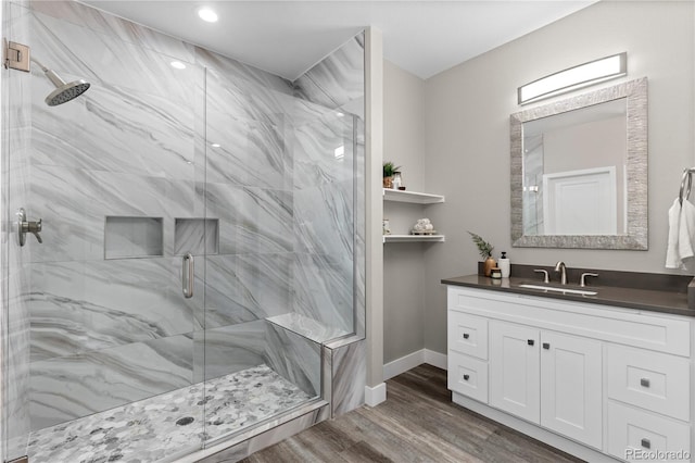 bathroom featuring hardwood / wood-style flooring, vanity, and an enclosed shower