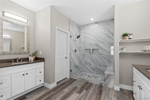 bathroom with vanity, an enclosed shower, and hardwood / wood-style floors