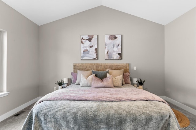 carpeted bedroom with vaulted ceiling