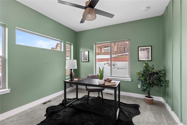 carpeted office space featuring a wealth of natural light and ceiling fan