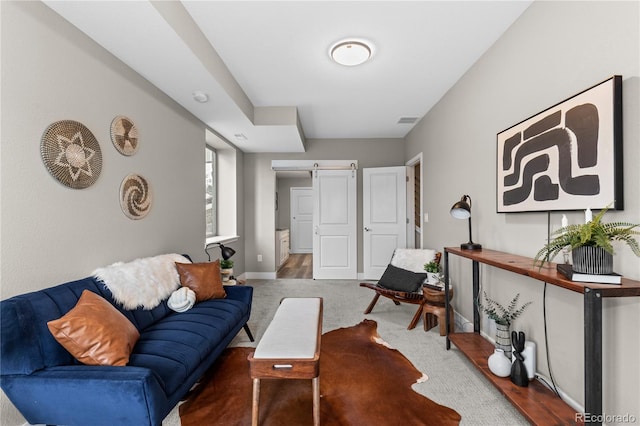 living room featuring wood-type flooring and a barn door