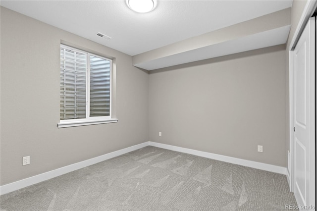 interior space with light colored carpet and a closet