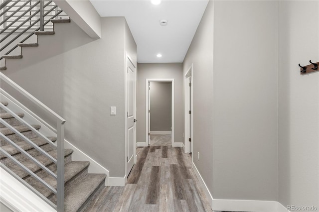 hallway with hardwood / wood-style floors