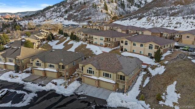 snowy aerial view with a mountain view