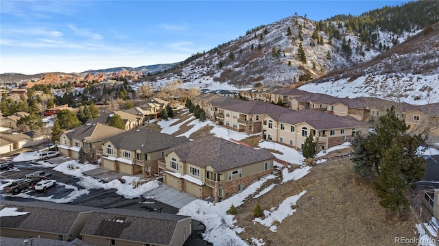 snowy aerial view featuring a mountain view