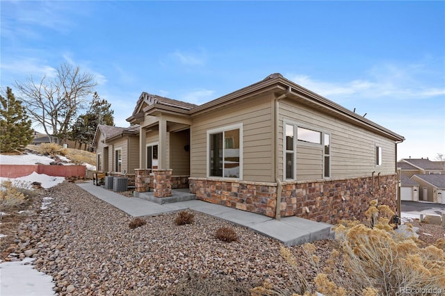 view of side of home with cooling unit and a patio area