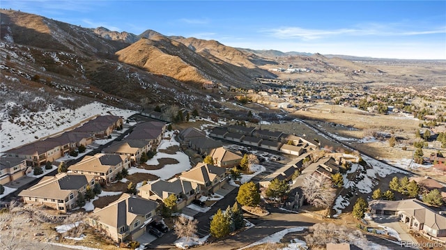 snowy aerial view with a mountain view