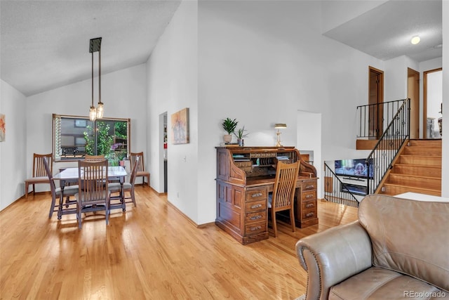 3688 S Cathay Cir, Aurora, CO 80013 - dining space featuring light wood finished floors, stairs, and high vaulted ceiling