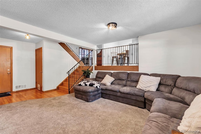 3688 S Cathay Cir, Aurora, CO 80013 - carpeted living area with stairs, wood finished floors, and a textured ceiling