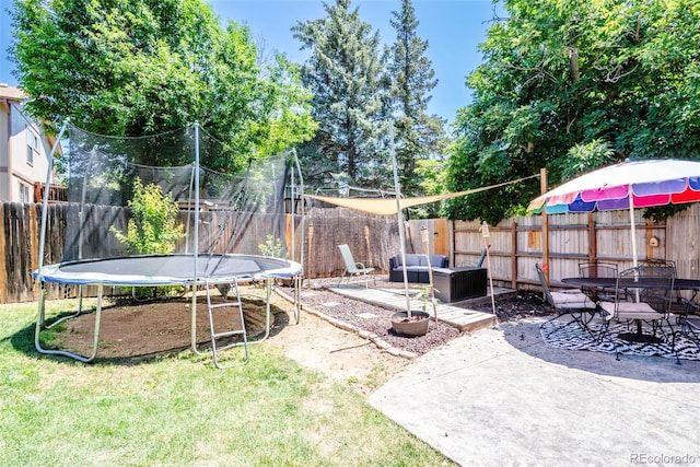 3688 S Cathay Cir, Aurora, CO 80013 - fenced backyard with a trampoline, a patio, an outdoor hangout area, and outdoor dining space