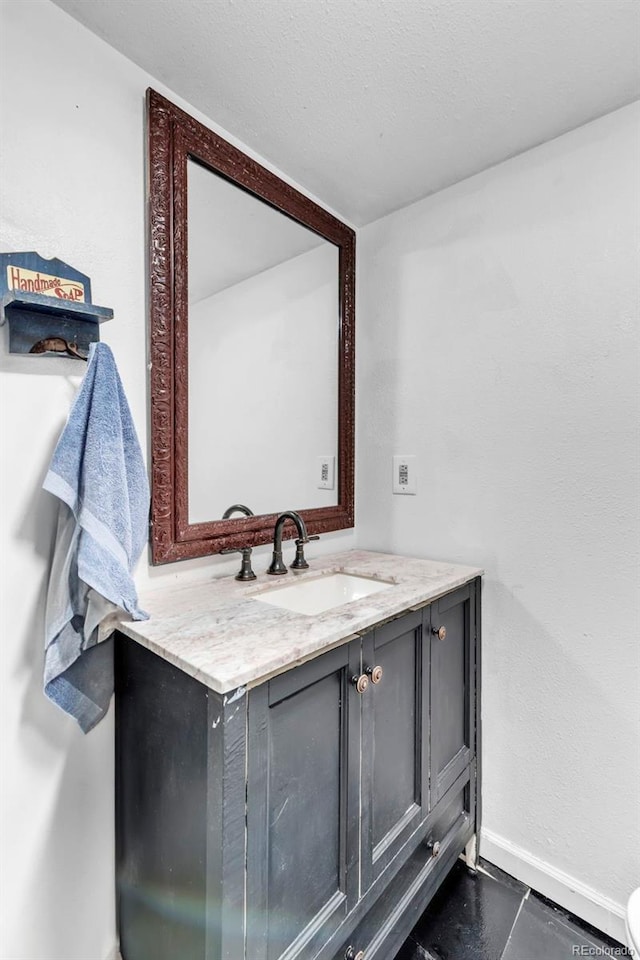 3688 S Cathay Cir, Aurora, CO 80013 - bathroom featuring baseboards and vanity