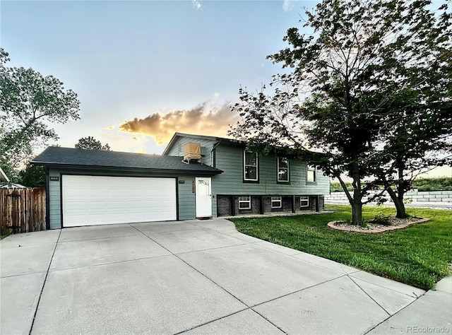 4303 S Yank St, Morrison, CO 80465 - tri-level home featuring concrete driveway and an attached garage