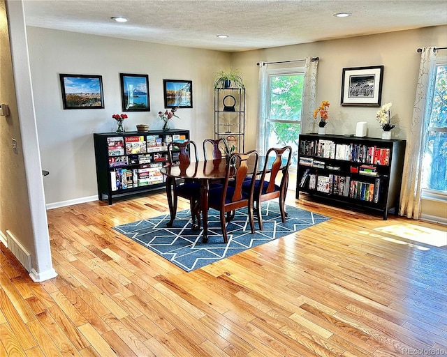4303 S Yank St, Morrison, CO 80465 - dining area with light wood finished floors, a textured ceiling, recessed lighting, and baseboards