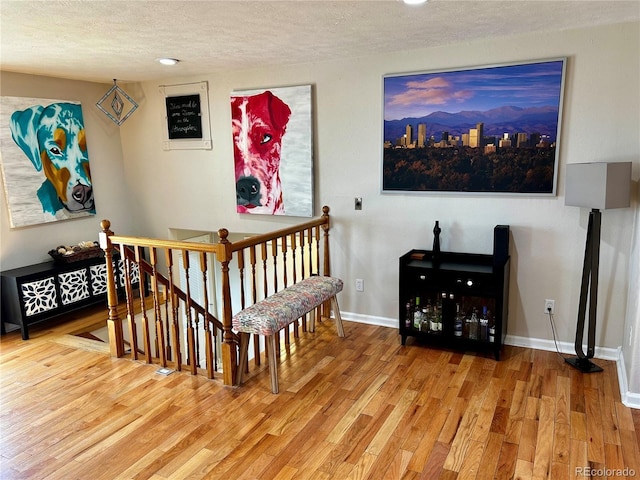 4303 S Yank St, Morrison, CO 80465 - staircase with a textured ceiling, wood finished floors, baseboards, and recessed lighting
