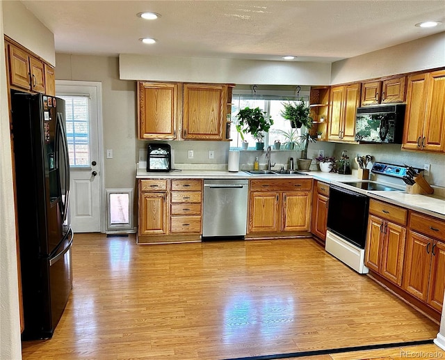 4303 S Yank St, Morrison, CO 80465 - kitchen with black appliances, a sink, brown cabinetry, and recessed lighting