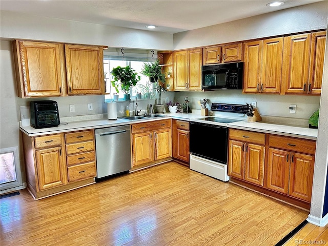 4303 S Yank St, Morrison, CO 80465 - kitchen with black microwave, stainless steel dishwasher, electric range, a sink, and brown cabinetry