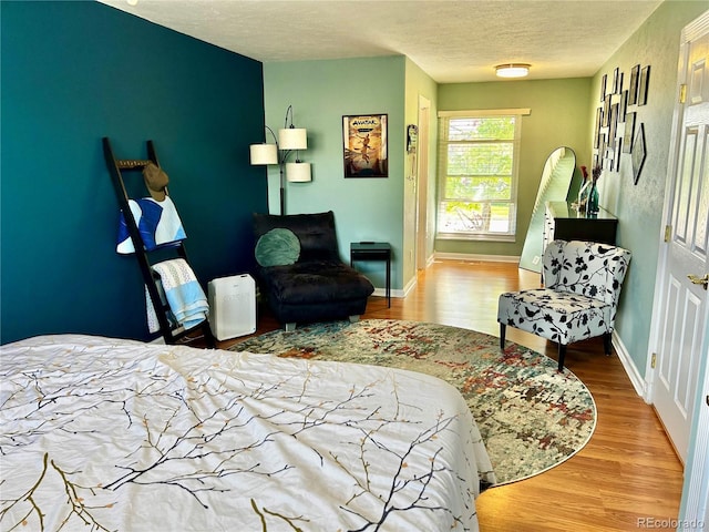 4303 S Yank St, Morrison, CO 80465 - bedroom with wood finished floors, a textured ceiling, and baseboards
