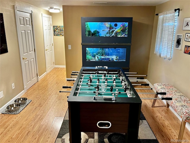 4303 S Yank St, Morrison, CO 80465 - recreation room with wood finished floors and baseboards