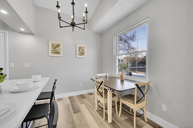 dining room featuring light hardwood / wood-style floors and a chandelier