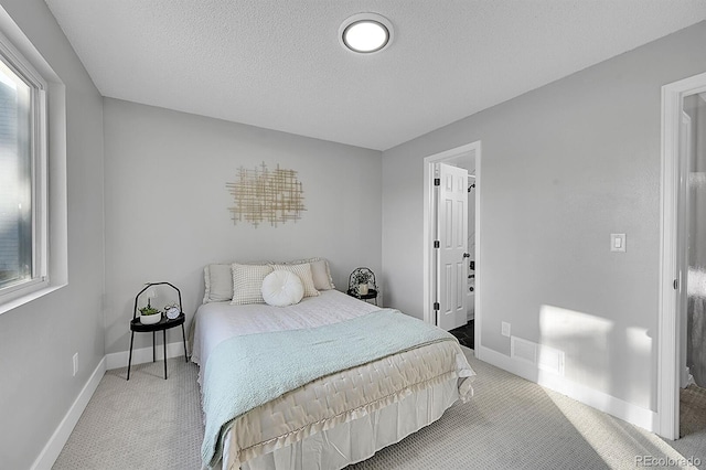 bedroom with carpet and a textured ceiling