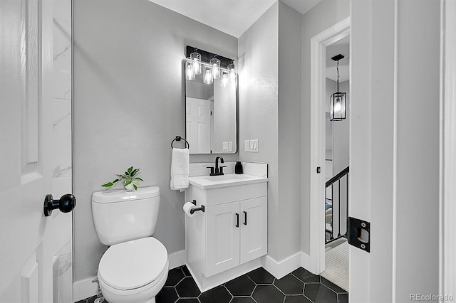 bathroom with tile patterned flooring, vanity, and toilet