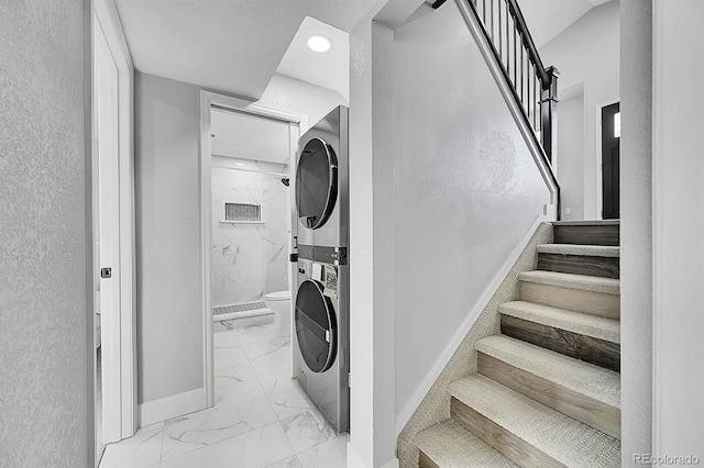 laundry room with stacked washing maching and dryer