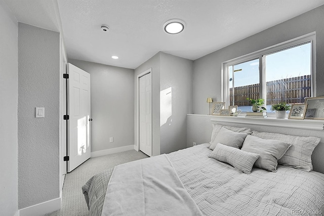 bedroom with light colored carpet and a closet