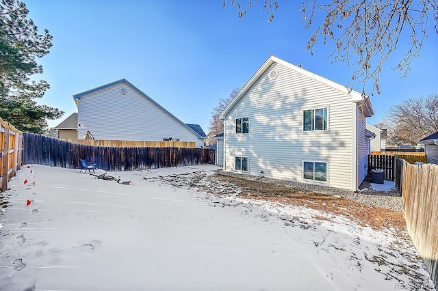 view of snow covered rear of property