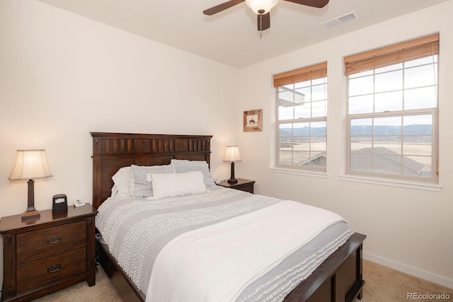 bedroom with light carpet and ceiling fan