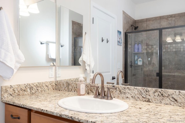 bathroom with vanity and an enclosed shower