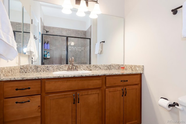 bathroom with vanity and a shower with door