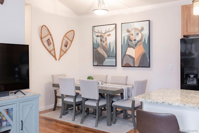 dining space with light hardwood / wood-style flooring