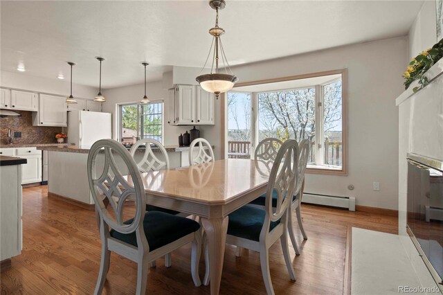 6492 S Piney Creek Cir, Centennial, CO 80016 - dining room with a baseboard radiator, baseboards, wood finished floors, and recessed lighting