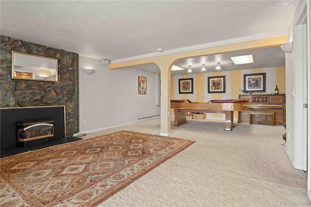 6492 S Piney Creek Cir, Centennial, CO 80016 - interior space featuring a textured ceiling, baseboards, carpet, a fireplace, and a baseboard radiator