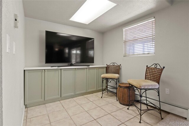6492 S Piney Creek Cir, Centennial, CO 80016 - living area with a baseboard radiator and light tile patterned floors