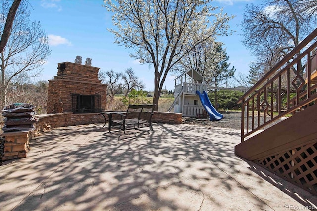 6492 S Piney Creek Cir, Centennial, CO 80016 - view of patio / terrace with an outdoor stone fireplace and a playground