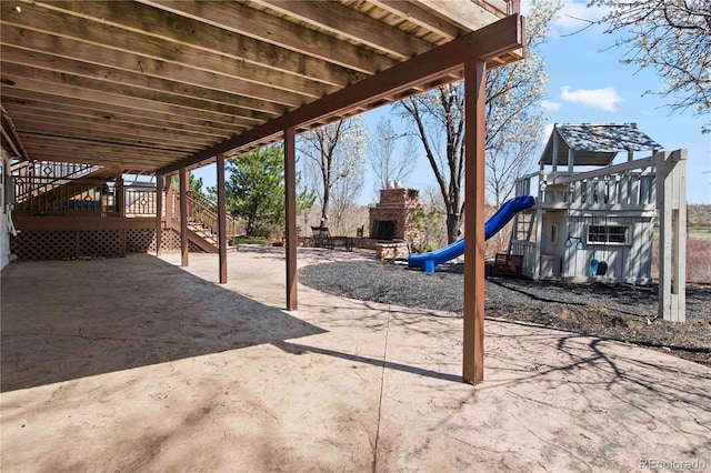 6492 S Piney Creek Cir, Centennial, CO 80016 - view of patio with stairs, an outdoor fireplace, and a playground