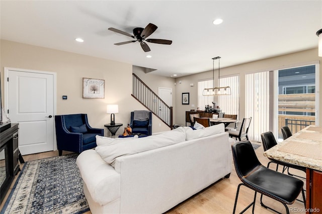8186 E 53rd Dr, Denver, CO 80238 - living room with light wood-type flooring, a ceiling fan, stairs, recessed lighting, and a chandelier
