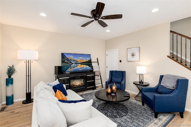 8186 E 53rd Dr, Denver, CO 80238 - living room featuring stairs, wood finished floors, ceiling fan, recessed lighting, and a glass covered fireplace