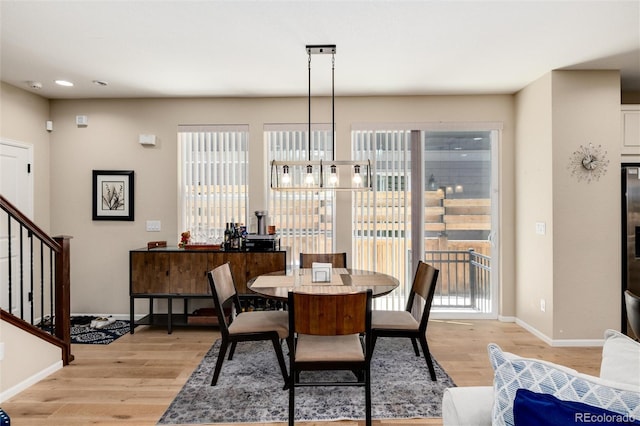 8186 E 53rd Dr, Denver, CO 80238 - dining area featuring light wood finished floors, stairs, a chandelier, plenty of natural light, and recessed lighting