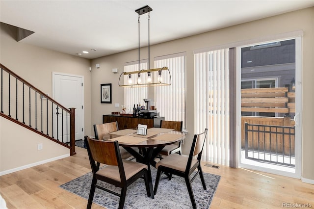 8186 E 53rd Dr, Denver, CO 80238 - dining space with light wood finished floors, stairway, recessed lighting, and a chandelier