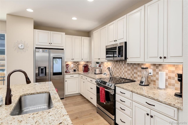 8186 E 53rd Dr, Denver, CO 80238 - kitchen featuring appliances with stainless steel finishes, white cabinets, decorative backsplash, and recessed lighting